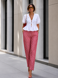Red woven checks pants with pintuck hem and elastic waist styled with white woven cotton top